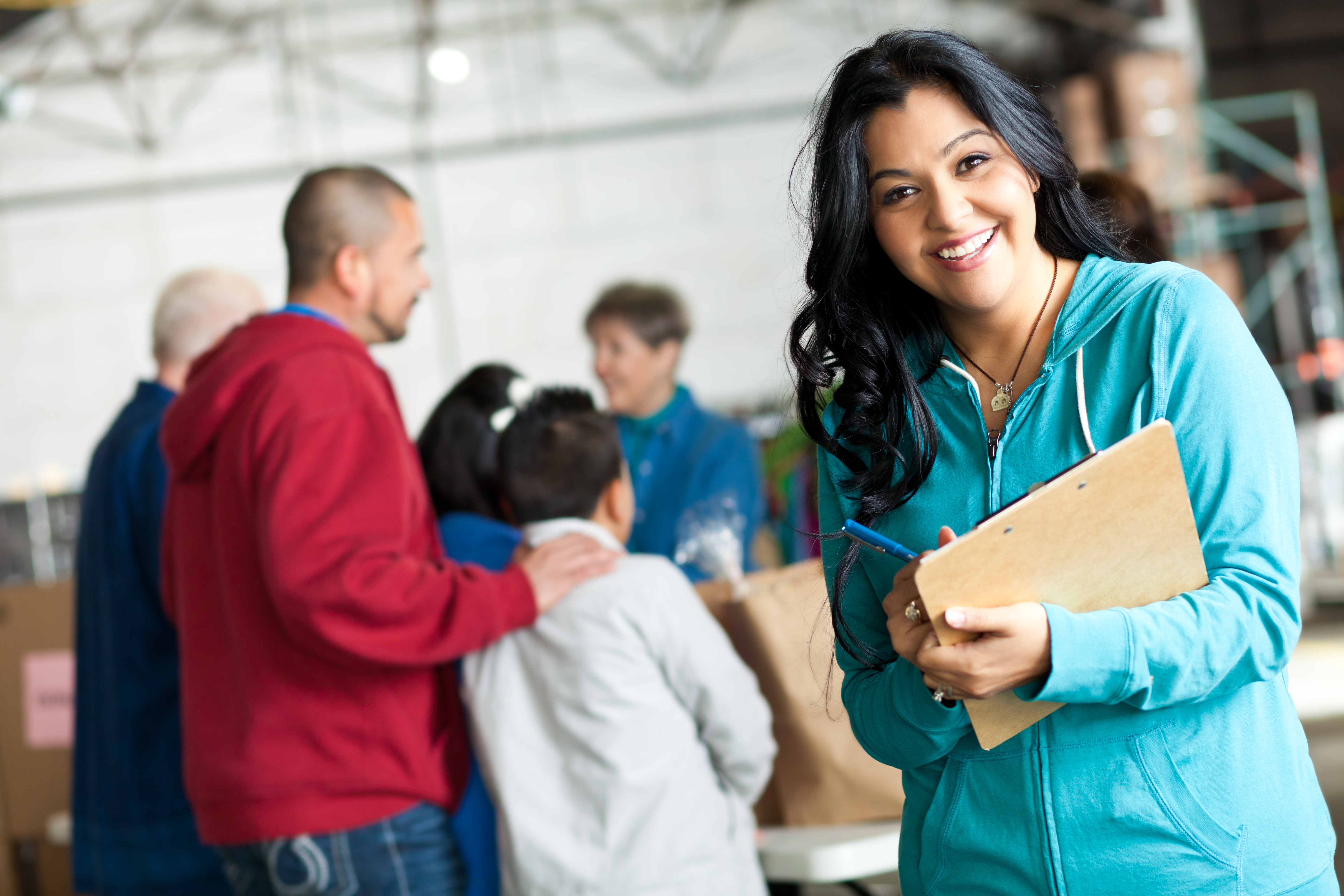 Young woman with clipboard at a donation relief center